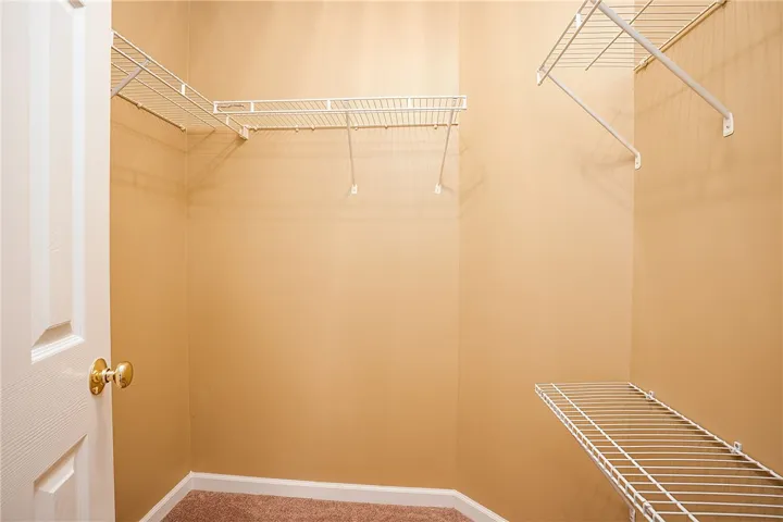 Ample wire shelving provides practical storage solutions within this neatly organized closet space.