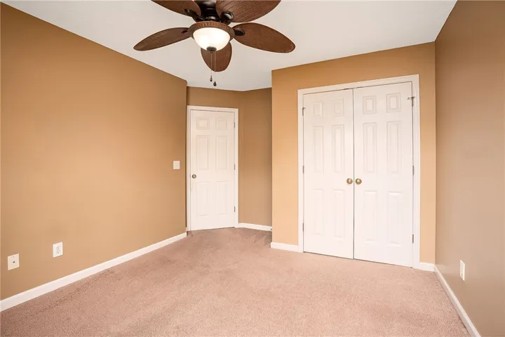 Cozy bedroom with plush carpeting and ample storage.