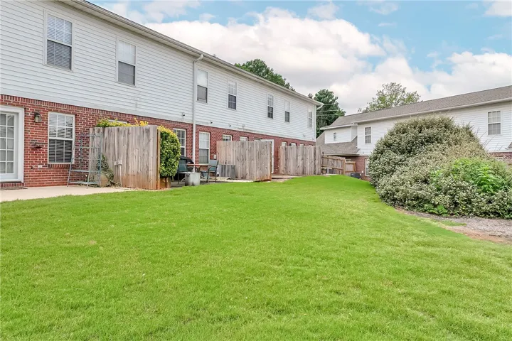 A fenced backyard offers a private green oasis for outdoor enjoyment.