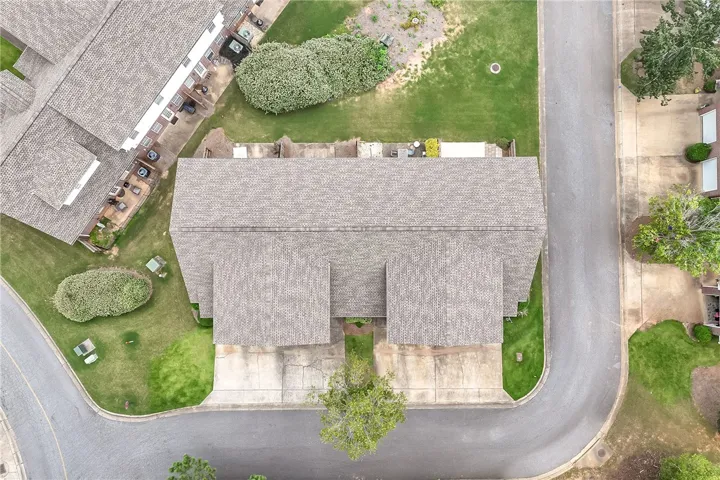 An aerial perspective reveals the well-maintained shingle roofs and manicured lawns of a charming residential development.