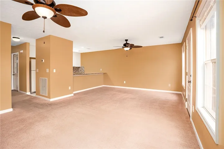 A versatile living space offers ample room for relaxation and entertaining, with abundant natural light.