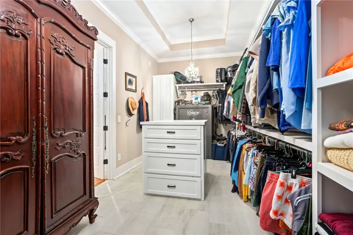 Ample storage solutions and elegant ceiling details define this dressing room.