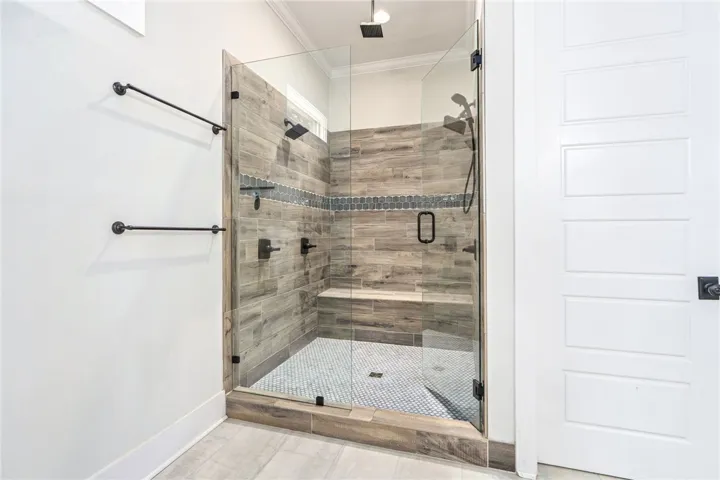A frameless glass shower enclosure creates an open, spa-like atmosphere in this refined bathroom.