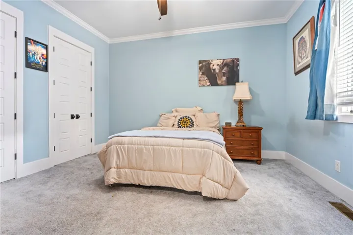 A comforting retreat with plush carpet and ample natural light from the well-placed window.