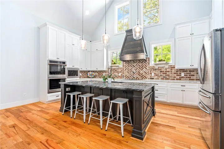 Culinary aspirations meet stunning design in this spacious kitchen featuring a grand island and high ceilings.