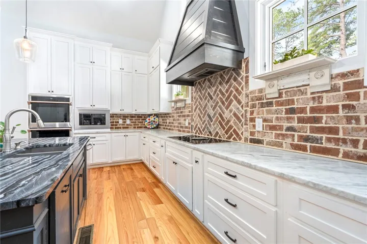 A well-appointed kitchen features a large island and ample counter space for culinary pursuits.