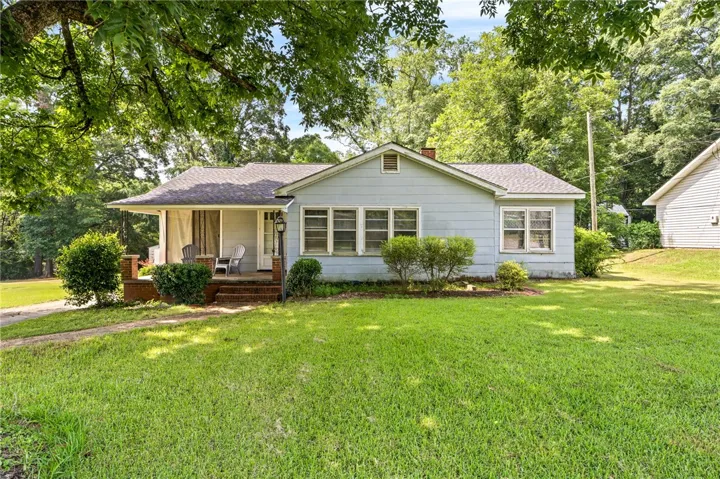 A classic ranch home nestled among mature trees and a manicured front yard awaits.