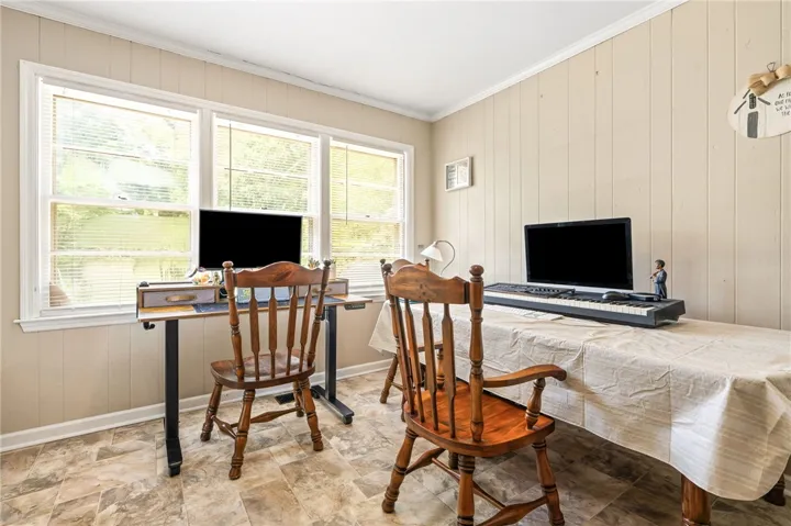 A well-lit room offers flexible space for work or creative pursuits, bathed in natural light.