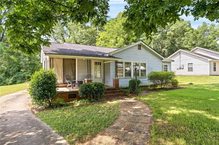 An inviting front porch with brick accents welcomes you to this charming residence.