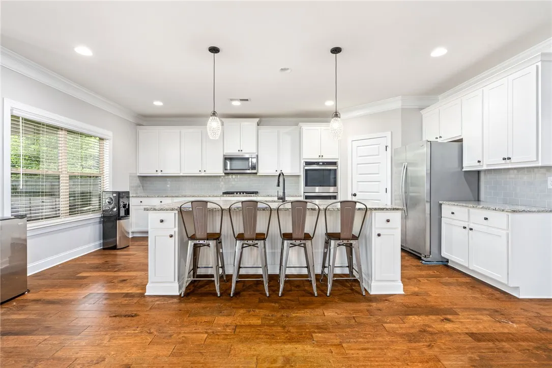 A well-appointed culinary space featuring sleek cabinetry and robust wooden flooring.
