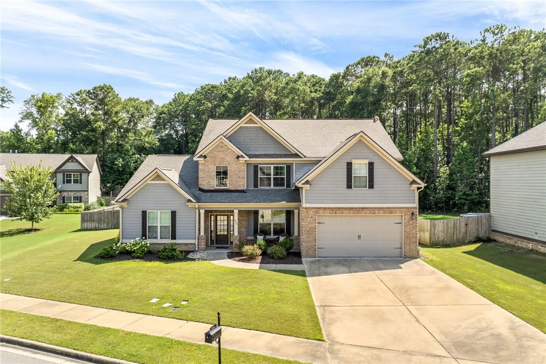 A classic facade of brick and siding welcomes you home with a double garage and mature landscaping.