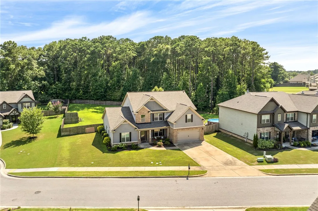 A classic facade with a mix of siding and brick accents, featuring a welcoming covered entry and an attached garage.