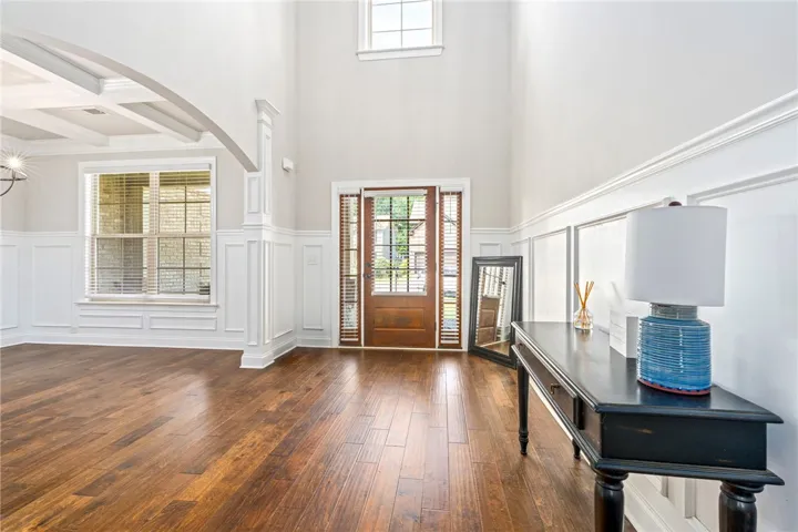 A grand entrance welcomes you with towering ceilings and rich hardwood flooring.
