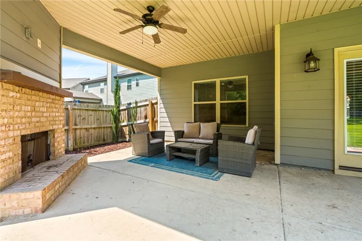 A spacious covered patio provides an outdoor fireplace and ample seating for enjoyment.