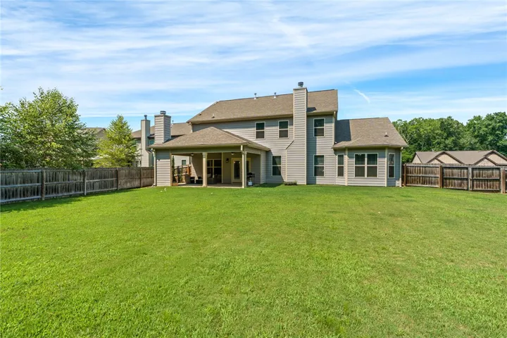 A spacious, fenced yard offers ample room for outdoor activities and private gatherings.