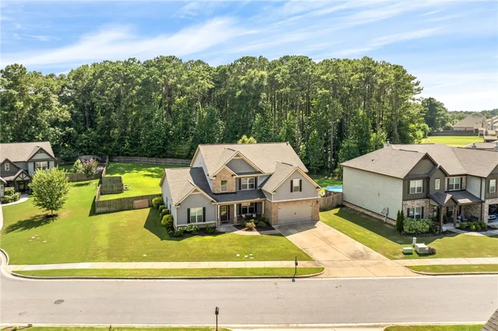 A classic facade with a mix of siding and brick accents, featuring a welcoming covered entry and an attached garage.