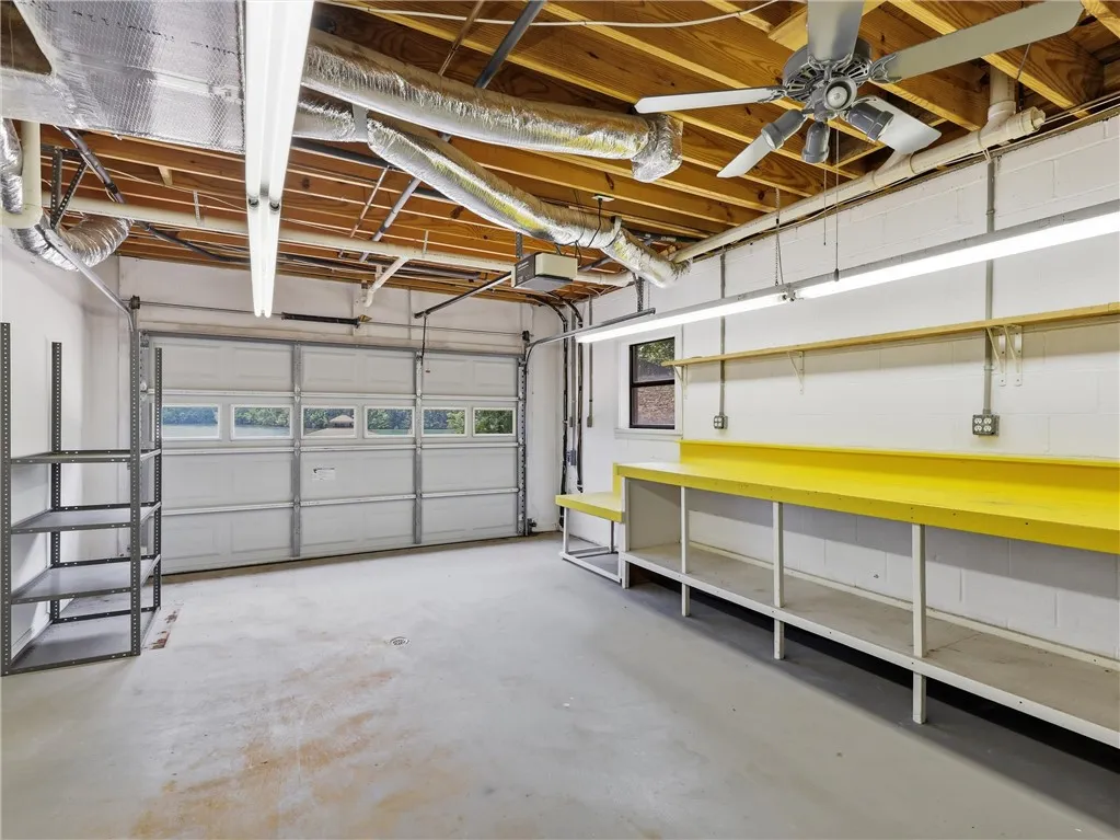 The one car garage is perfect for a golf cart or small boat.  It features an electric garage door, a separate driveway, a utility sink and a workbench.  There is a separate oversized two car garage on the main level as well.
