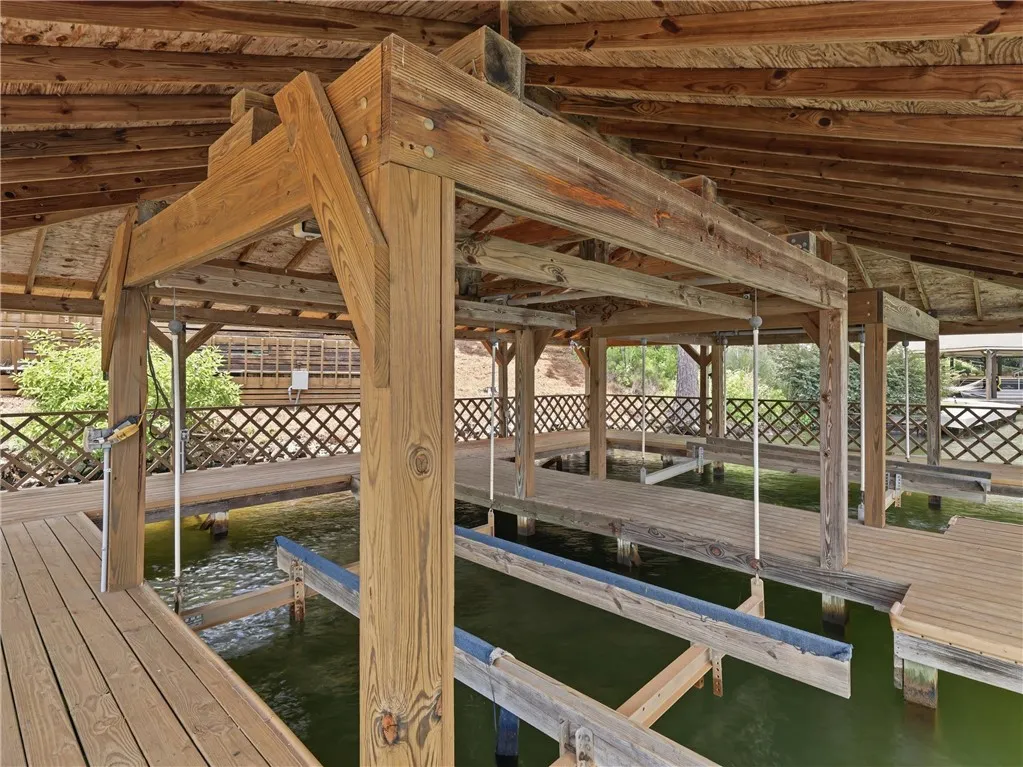 A private covered dock with multiple slips offers convenient waterfront access.