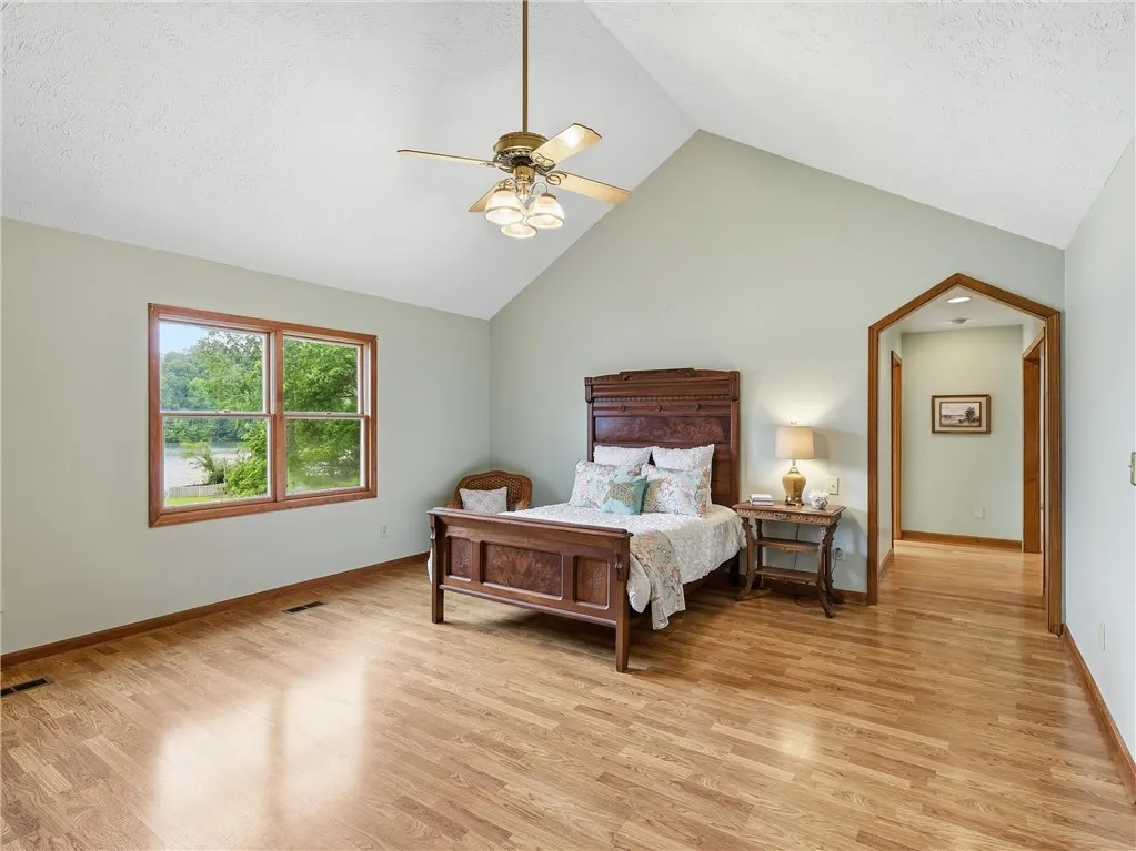 Just off the great room, the main bedroom showcases natural light and an elegant vaulted ceiling.  There are two closets and one is a walk in.