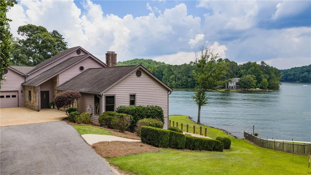 Lakeside living defines this charming home with an attached garage and scenic water views.