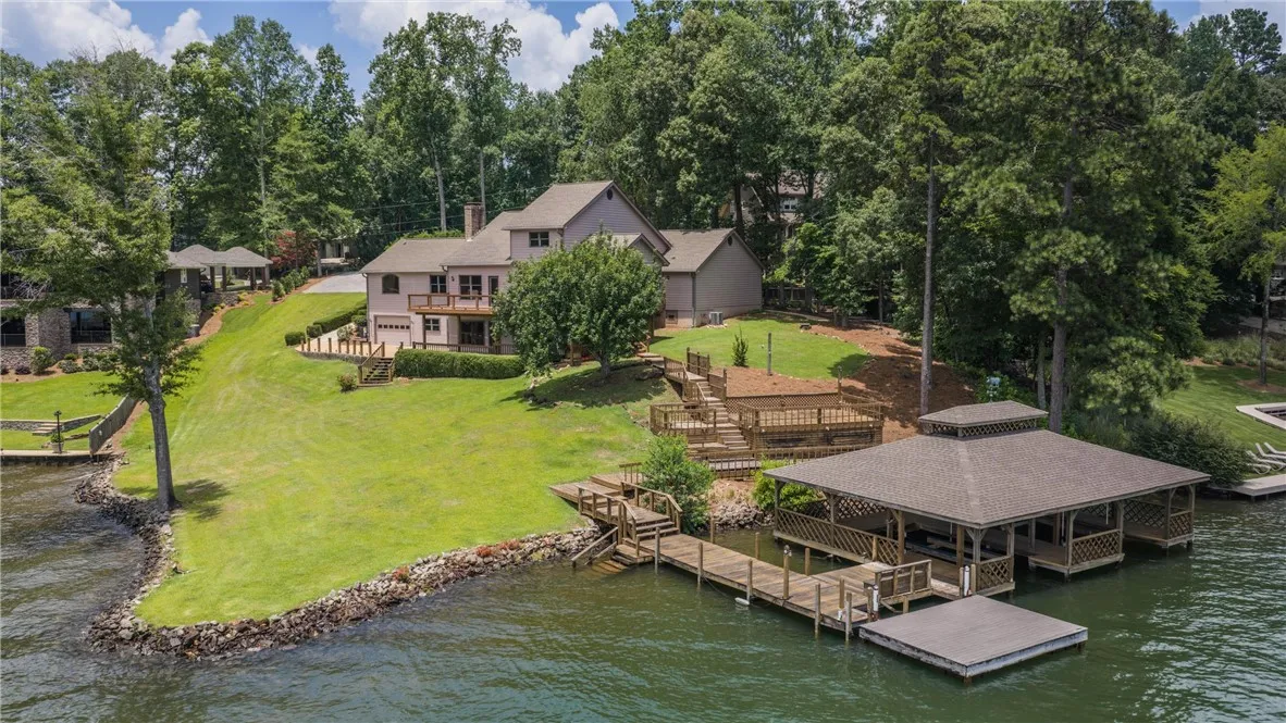 Lakeside living offers a double boat house with lifts  providing direct water access and recreational possibilities.