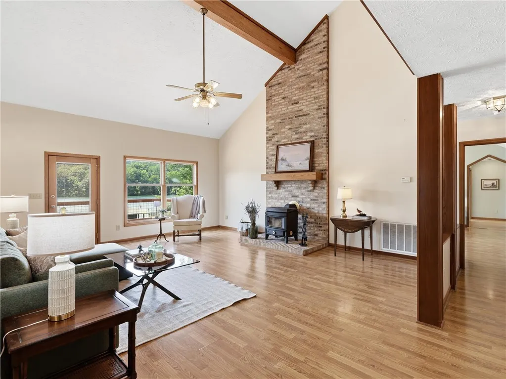 The brick chimney, wood burning stove and more gorgeous lake views complete the great room.