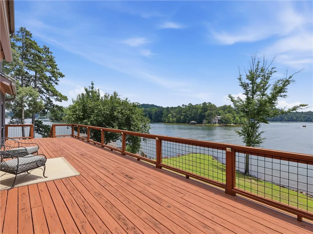 A spacious wooden deck provides ample outdoor living space with captivating lake views.