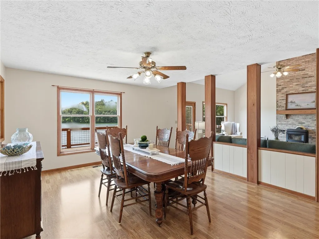 Dine with a view, as this welcoming room features a waterside window and entry to the screened in back porch.