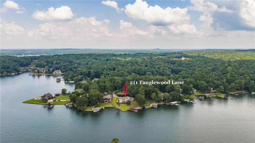 Discover a private lakefront home with ample greenery, offering serene water views and a peaceful setting.