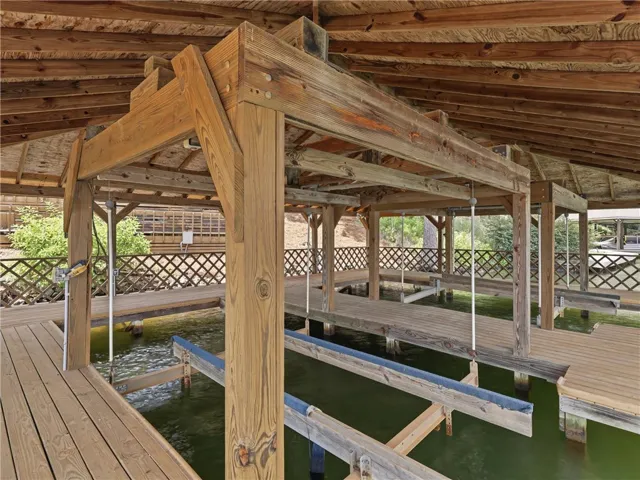 A private covered dock with multiple slips offers convenient waterfront access.