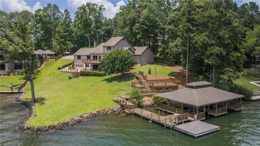 Lakeside living offers a double boat house with lifts  providing direct water access and recreational possibilities.