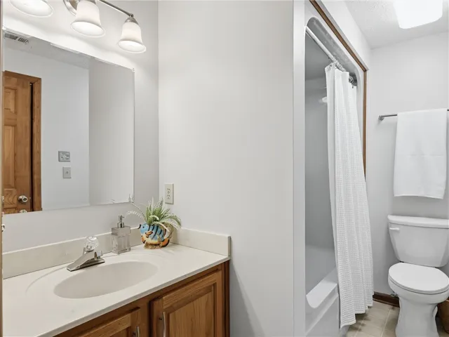 This freshly painted full bathroom completes the downstairs living space.