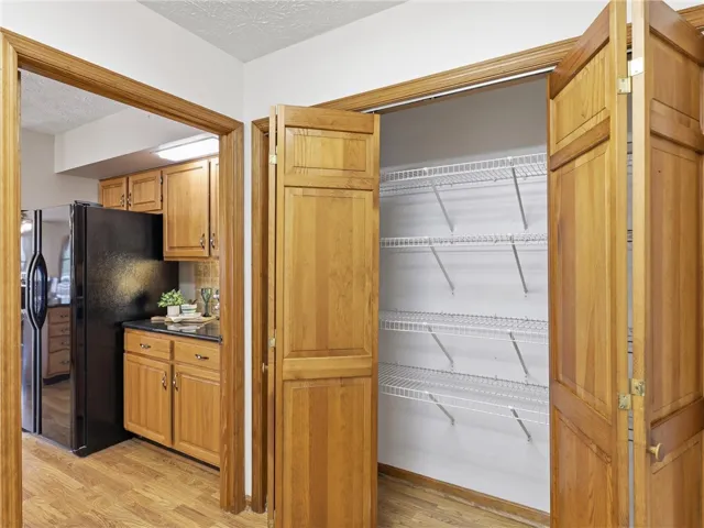 A convenient pantry with wire shelving provides ample storage adjacent to the functional kitchen.  This pantry is located in the laundry room.