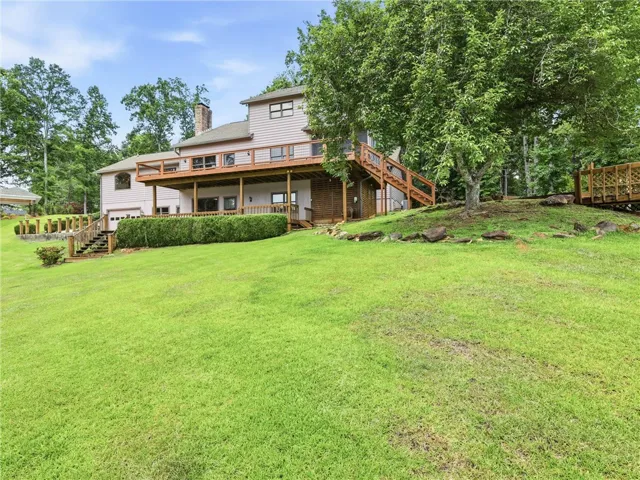 Two levels of deck extend almost across the entire front of the house.