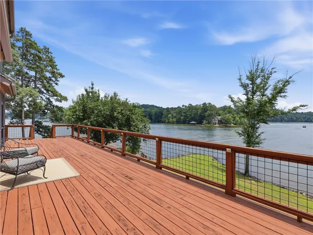 A spacious wooden deck provides ample outdoor living space with captivating lake views.