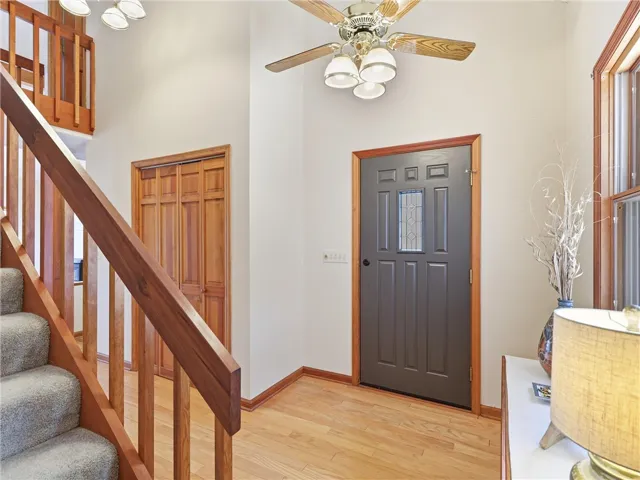 The hallway leading to the back of the house features a large storage closet and the stairway to the upstairs.  The exterior door has been freshly painted.