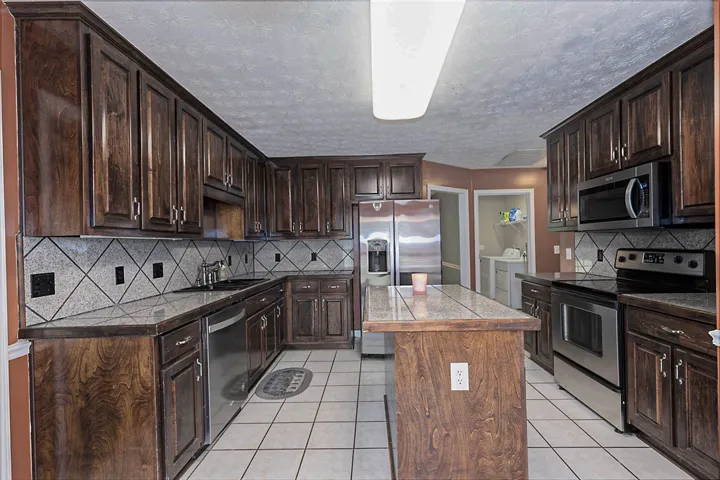 A well-appointed kitchen features rich wood cabinetry and modern stainless steel appliances.