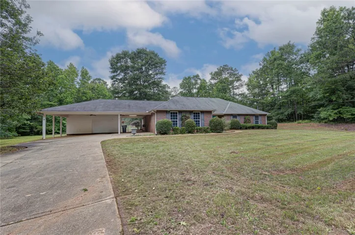 A classic brick-front home with a broad lawn and mature trees offers a private retreat.