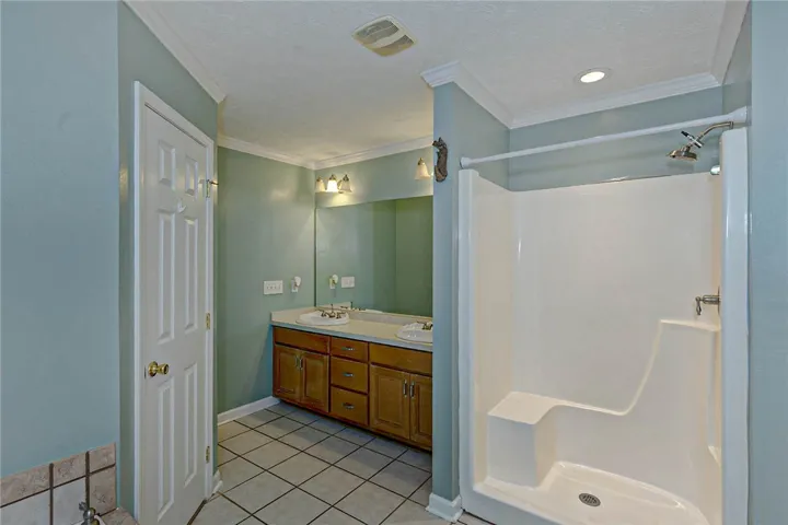 Dual vanities and a spacious shower create a highly functional bathroom.