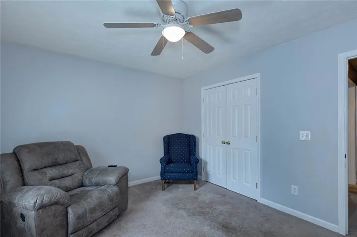 A comfortable bedroom with a ceiling fan offers a cozy retreat.