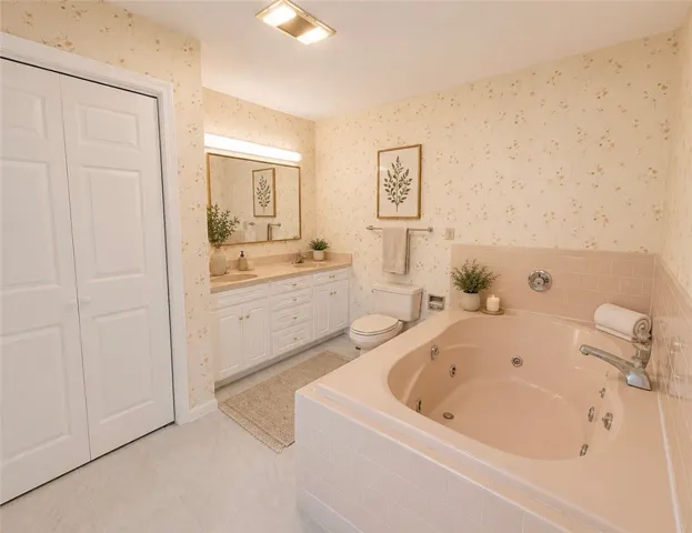 Relax in a soaking tub within this well-appointed bathroom, featuring a double vanity.