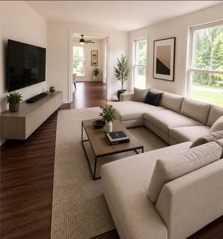 Natural light streams into this generously proportioned living room, boasting rich hardwood flooring.