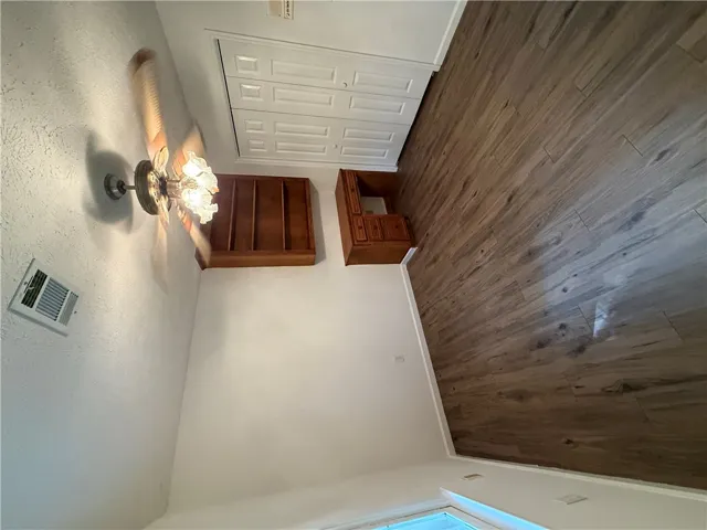 Wood plank flooring and a classic ceiling fan create a comfortable interior space.