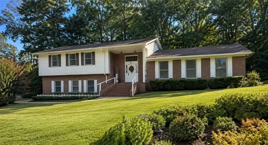 A well-maintained residence with mature landscaping and an inviting front entry.