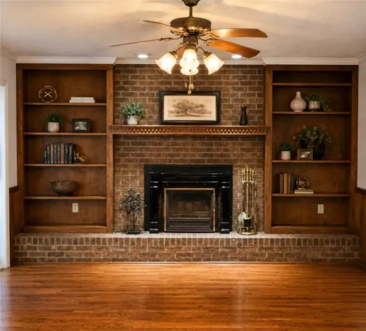 A classic brick fireplace with built-in bookshelves creates a warm, inviting living space.