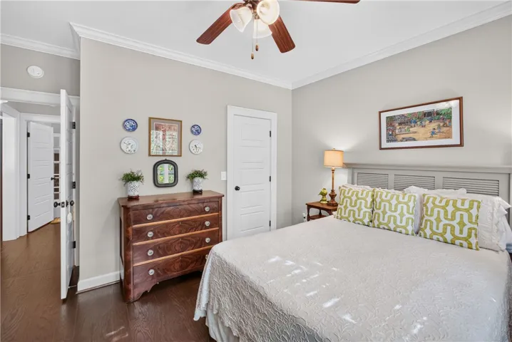 Hardwood flooring flows through this bright primary bedroom, offering ample natural light.