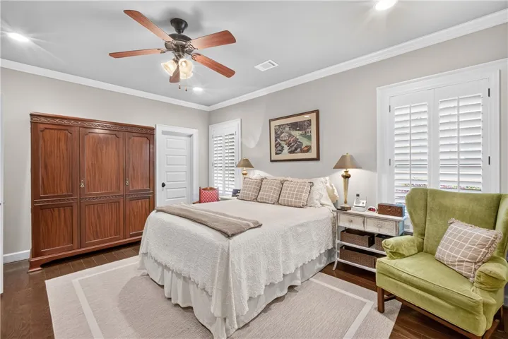 Hardwood floors and bright windows illuminate this comfortable, well-appointed sleeping sanctuary.