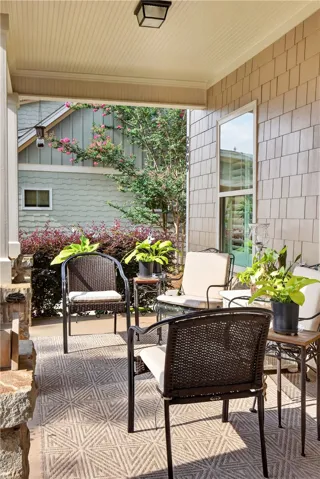 An inviting covered porch offers a serene spot for relaxation and outdoor enjoyment.