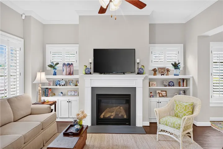 A comforting living area boasts a central fireplace, flanked by custom built-in shelving.