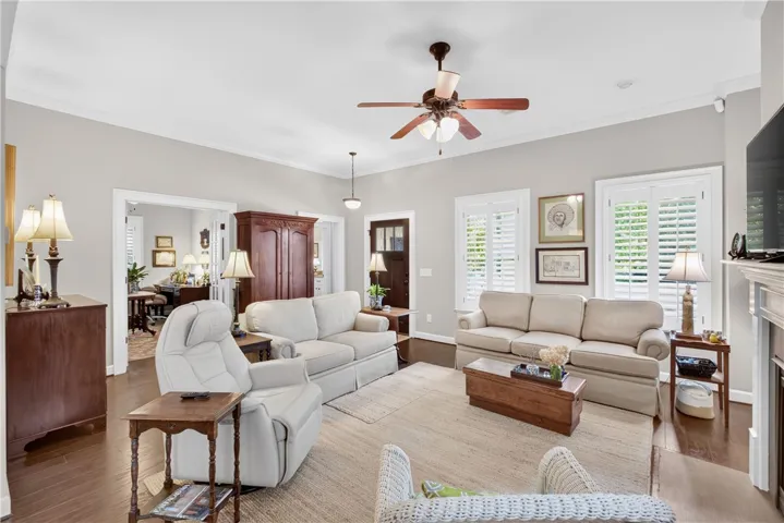 Hardwood floors and crisp white crown molding define this inviting living space.